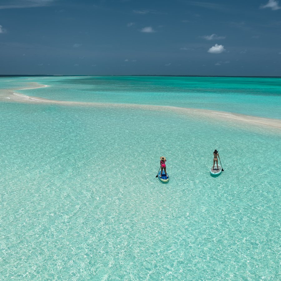 Two paddleboards on a shallow turquoise sandbank